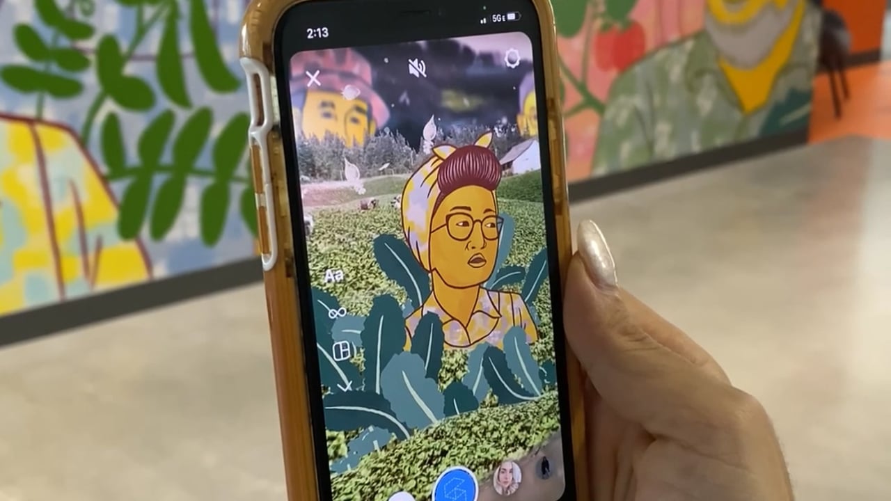 An animated farmer appearing in augmented reality over the mural