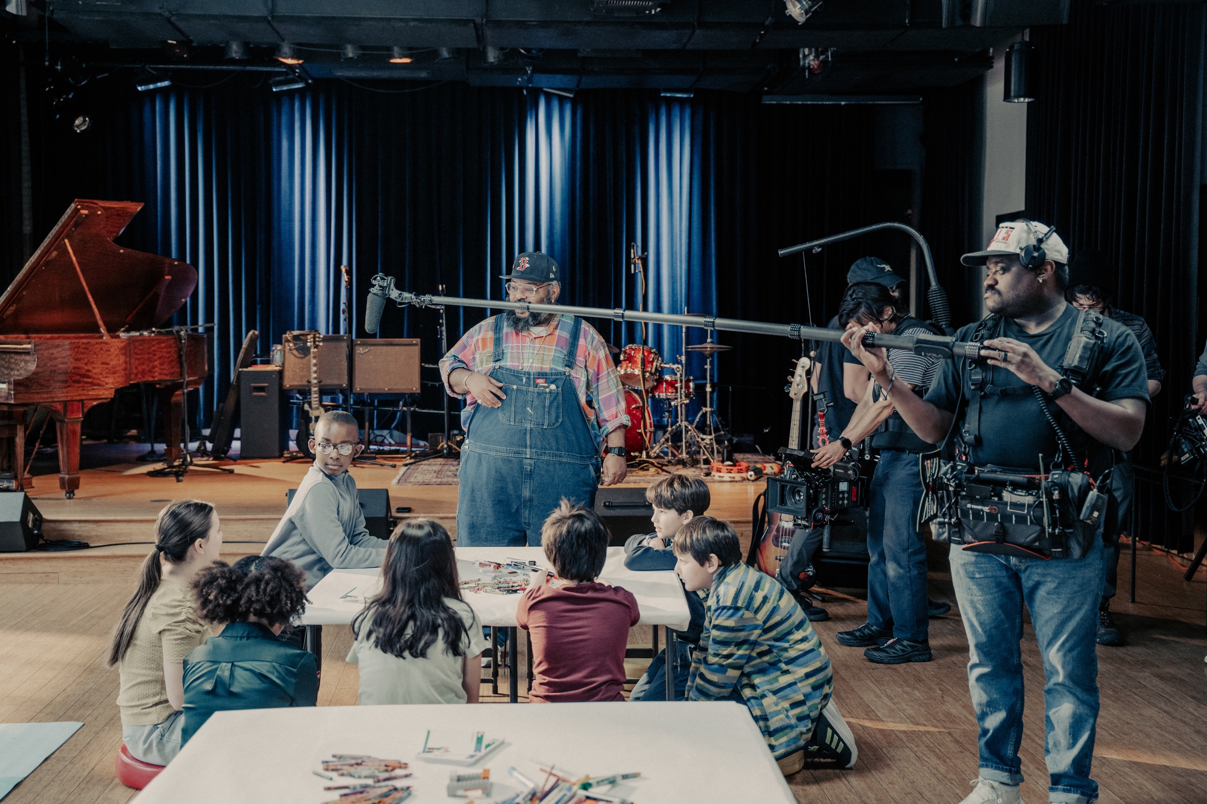 Film crew capturing children building with LEGO bricks at ZUMIX in Boston